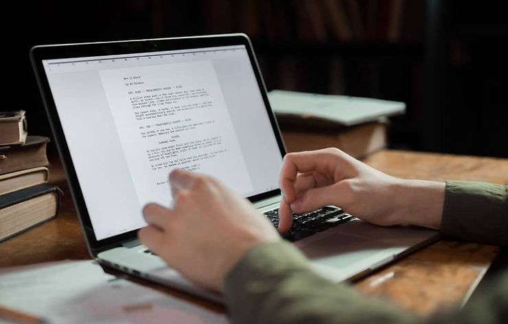 Writing job description on laptop