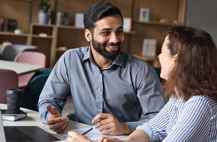 Two people discuss competency based hiring