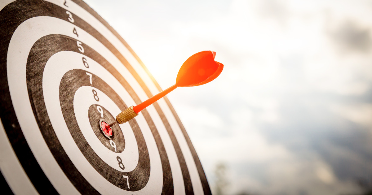 Dart embedded in the bullseye of a target