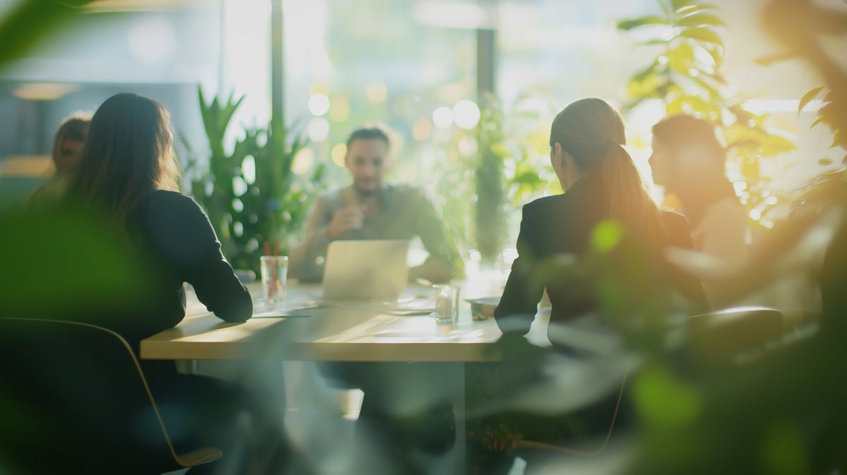 Team sitting around a conference table holding a meeting