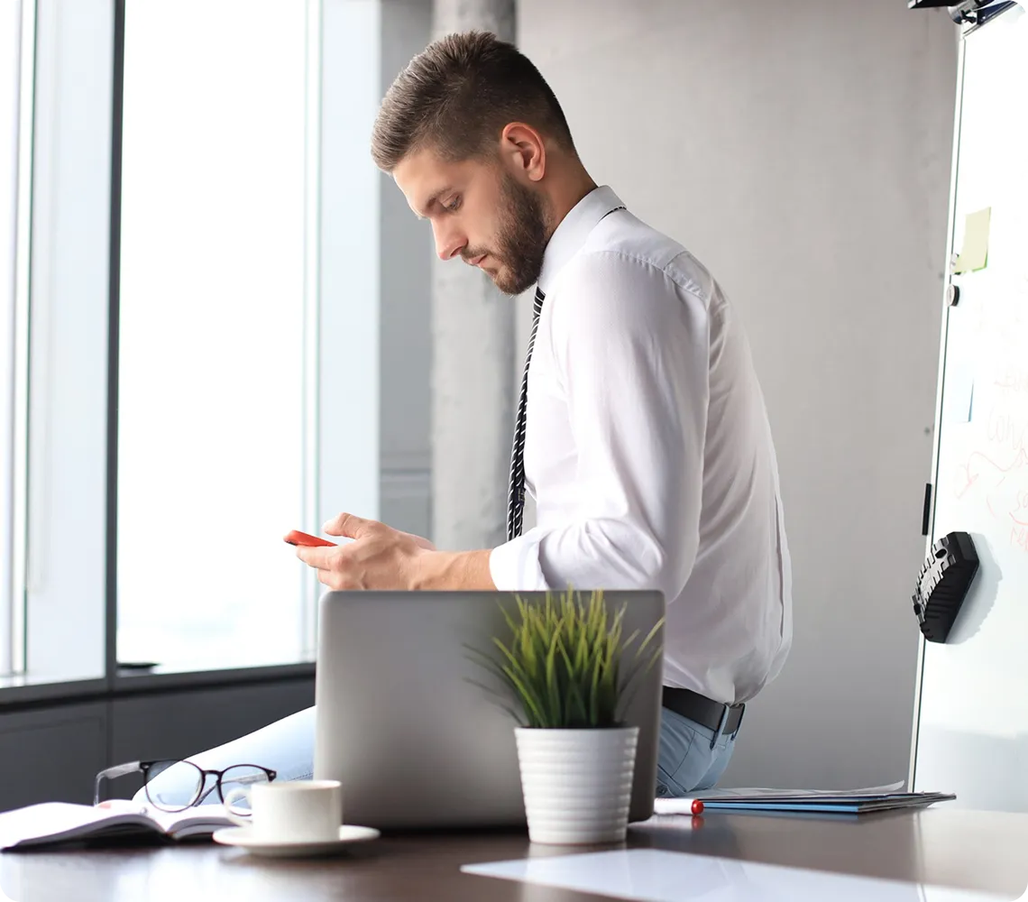 Men sitting on table using phone