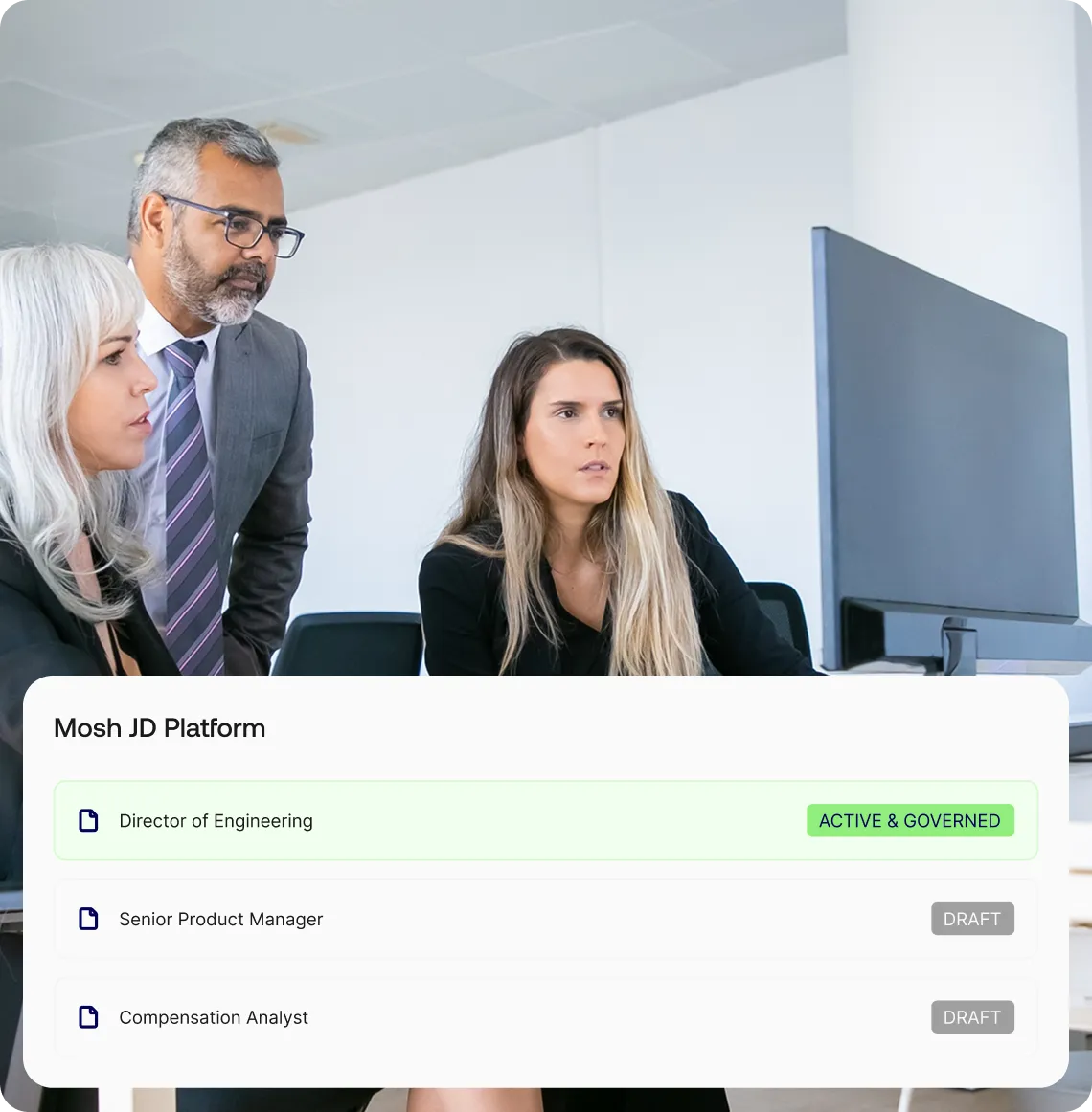 Three colleagues collaborating in an office Mosh JD platform interface showing active and draft role statuses.